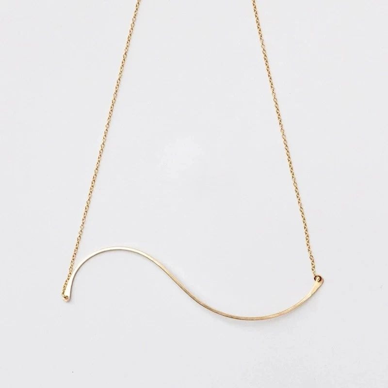 Gold curved bar necklace minimalist design